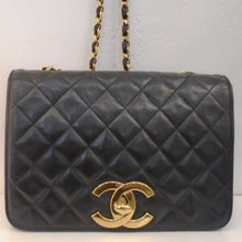 Load image into Gallery viewer, This Chanel Vintage Two Way Flap Bag is in the stitched diamond pattern with 24 karat gold hardware. It has a large Chanel Logo in gold on the bottom center flap. The shoulder chain is gold with a thin black leather strip running through the chain links. This bag has a burgundy interior with pockets.