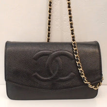 Load image into Gallery viewer, This Chanel Vintage Black Caviar Leather Half Moon WOC has gold hardware and a zippered opening on the back of the bag. The shoulder chain has a black strip of leather woven between the chain links. The front flap comes three quarters the way down the front of the bag with the CC logo embroidered in the center. The flap end has a half moon shape. The interior of the bag is also black leather and has two zippered pockets and pockets for holding cards.