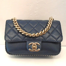 Load image into Gallery viewer, This Chanel Vintage Blue Caviar 2-Way is navy blue with gold hardware. The back and front flap are diamond stitched with the lip fastening over a smooth front body. The double CC logo is on the lip as a fastener. It also has gold beaded trim on the front edge of the bag. The shoulder strap is partially a gold chain and leather adjustable strap. The interior of this bag is the same navy tint as the outside with a zippered pocket.