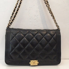 Load image into Gallery viewer, This Chanel Vintage Boy WOC is black with the diamond stitched design on front and back of the bag. It has gold hardware which includes the logo clasp at the bottom of the front full flap. It has a double gold shoulder chain with a leather strip woven between the links. The interior of this bag is black with a zippered pouch and card holders.