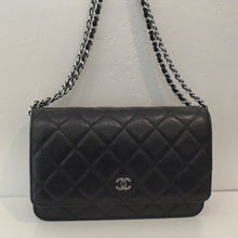 Load image into Gallery viewer, This Chanel Vintage Caviar Leather Navy WOC With Silver Hardware has the original Chanel Diamond Stitching and a small Chanel logo in silver. The interior of this bag is also Navy with a zippered pouch.