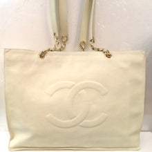 Load image into Gallery viewer, This Chanel Vintage Caviar Large Tote is in Ecru White and has the CC logo stitched on the front of the bag. It has double leather shoulder straps attached to short gold chains which are attached to the top of the bag. The interior of the bag is the same Ecru white shade.
