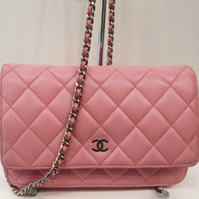 Load image into Gallery viewer, This Chanel Vintage Lambskin Pink WOC has silver hardware which consists of the WOC chain, which has a pink leather strip woven between the links, and the CC logo on the front of the bag. The bag is in the chanel stitched diamond pattern and has a pocket on the back of the bag. The interior of this bag is also pink and has a zipper on the underside of the front flap.