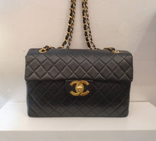 Load image into Gallery viewer, This Chanel Vintage Collectable has 24 Karat Gold Plated hardware. The CC logo clasp has an indented square on one of the Cs. The body of the bag is diamond stitched lambskin and it has a pocket on the back. It has a double shoulder chain with a thin black leather strip woven between the links. The interior of this bag is burgandy.