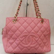 Load image into Gallery viewer, This Chanel Vintage Pink Caviar Leather Boston Bag has the chanel diamond pattern with the CC logo embroidered on the front of the bag. It has gold hardware, a double gold chain shoulder strap with pink leather strips woven inside it. The bag has a top zippered opening and is spacious inside.