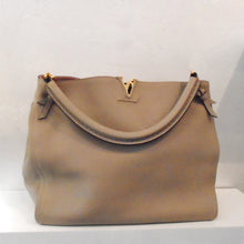 Load image into Gallery viewer, This Louis Vuitton Beige Taurillon Leather Tournon Galet has a thick sturdy carrying handle that can also be worn on the shoulder. It has gold hardware and the interior is pink.