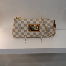 Load image into Gallery viewer, This Louis Vuitton Vintage Damier Azur Eva Pochette has gold hardware which includes the name plate on the front center of the bag. It has camel trim and includes a detachable camel leather strap. The interior of this bag is a light camel.