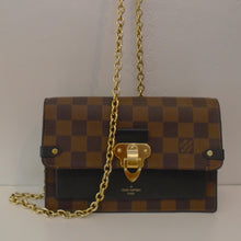 Load image into Gallery viewer, This Louis Vuitton Vintage Damier Ebene Vavin Chain Wallet is in the brown Damier Ebene pattern with gold hardware. It has a solid black section on the front body of the bag with "Louis Vuitton Paris" written in gold on the center bottom. The shoulder chain and front center latch is gold. The interior is black with a zippered section.