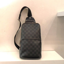 Load image into Gallery viewer, This Louis Vuitton Vintage Damier Graphite Sling Bag has a top and middle zippered compartment and a sturdy canvas strap. It has two interchangable rings on the bottom for hooking the strap.