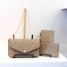 Load image into Gallery viewer, This Louis Vuitton Vintage Felicie Pochette is in the color turtle dove. It is in empriente leather with the monogram pattern embossed in the leather. It has gold hardware and a long shoulder chain. The pochette snaps together in the front. Included is a card holder and pouch.