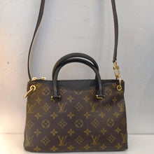 Load image into Gallery viewer, This Louis Vuitton Vintage Monogram/Black Pallas BB is a black leather bag with original monogram on both sides of the bag leaving the sides showing the black bag. It has two carrying handles and a long detachable shoulder strap included. The bag has gold hardware and a black interior.