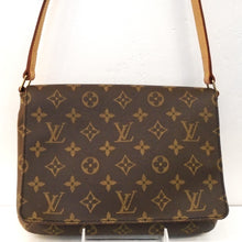 Load image into Gallery viewer, This Louis Vuitton Vintage Monogram Musette Tango Shoulder Bag is in the original brown tone monogram pattern. It has gold hardware and camel trim. It has an adjustable buckle shoulder strap and a deep brown interior.