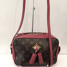 Load image into Gallery viewer, This Louis Vuitton Vintage Monogram Saintonge/Hot Pink Leather bag has hot pink trim, a long shoulder strap and top access double end zippers. It has gold trim and double leather tassels on the front of the bag. The interior is the same hot pink shade as the trim.
