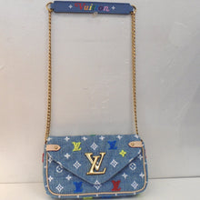 Load image into Gallery viewer, This Louis Vuitton Vintage New Wave Denim Crossbody has a gold chain shoulder strap with a denim shoulder strap protector that has the word vuitton embroidered on it in colorful stitching. It has gold hardware and beige trim. It has the Louis Vuitton Logo in gold on the front flap of the bag. The interior is a soft denim color.