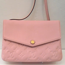Load image into Gallery viewer, This Louis Vuitton Vintage Pink Empreinte Leather Twice is a lovely shade of soft pink. The body of the bag is Imprinted with the Louis Vuitton monogram but the front flap and strap are smooth. The interior of this bag is a lighter shade of pink. The front V shaped flap simply snaps together with a gold snap.