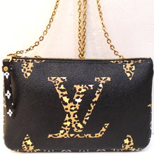 Load image into Gallery viewer, This Louis Vuitton Vintage Reverse Jungle Double Pochette Crossbody has gold hardware and two different sides. One side has a black background with large monogram in lepord. The other side has smaller white monogram against a background of light and dark camel tiger stripes. The inside has a zippered pocket which has both designs and a cardholder that is black with white monogram.