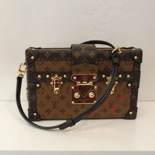 Load image into Gallery viewer, This Louis Vuitton Vintage Reverse Monogram Malle Crossbody Petite is in the appearance of a steamer trunk and has gold hardware and a leather crossbody strap. It has three red x's on the front right bottom of the bag which denotes the Kabuki Face Motif. The interior of this bag is brown and has a diamond design on the inside top.
