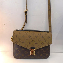 Load image into Gallery viewer, This Louis Vuitton Vintage Reverse Monogram M`etis Pochette has a combination of dark-light to light-dark monogram pattern. The top flap is light to dark monogram and the rest of the bag is dark to light monogram. The shoulder strap is adjustable and the interior of the bag is black.