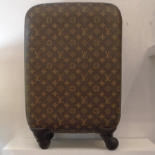 Load image into Gallery viewer, This Louis Vuitton Monogram Zephyr 55 Hard Case Suitcase is in the brown monogram pattern and has a gold zipper that runs along the side of the case for opening. It sits on two wheels and has a pull out handle on the top of the case. The inside of this case has two zippered compartments on one side and the other side has the depth of that side for storage. There is a flap that covers both sides of the inside.