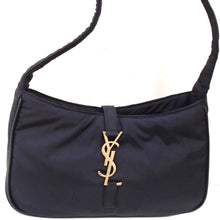 Load image into Gallery viewer, This YSL Navy 5 `A 7 Hobo Bag is a deep navy color and a very soft silky feeling bag. It has gold hardware and the top opening of the bag is closed by hooking the YSL logo, which is connected from the back by a fabric strip into a fabric loop on the front bottom. The interior of the bag is the same econyl material.