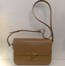 Load image into Gallery viewer, This Celine Bronze Classique Triomphe has gold hardware which includes the Celine Logo. The interior of the bag is a lighter bronze which actually looks more like a camel color. This bag has an adjustable shoulder strap.

