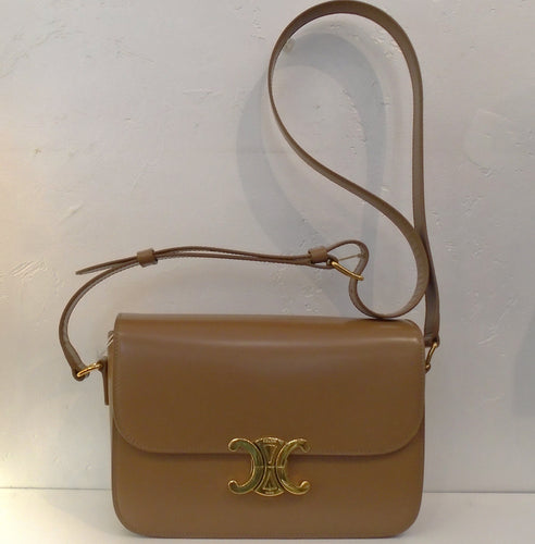 This Celine Bronze Classique Triomphe has gold hardware which includes the Celine Logo. The interior of the bag is a lighter bronze which actually looks more like a camel color. This bag has an adjustable shoulder strap.