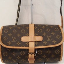 Load image into Gallery viewer, This Louis Vuitton Monogram Marne Shoulder Bag has light tan trim and an adjustable shoulder strap. The shape of the body of this bag is a barrel. The interior of this bag is a dark tan leather.
