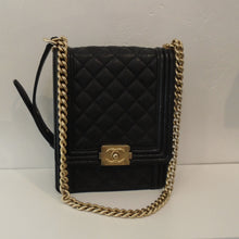 Load image into Gallery viewer, This Chanel Vintage Black Caviar Leather Le Boy Series 27 bag is in the quilted pattern with Gold Toned Hardware which includes the Chanel Logo clasp and shoulder chain. The shoulder chain has a leather shoulder guard. The interior of this bag is also black.
