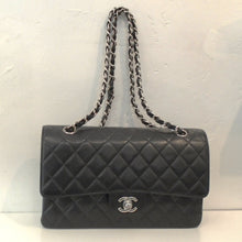 Load image into Gallery viewer, This Chanel Vintage Caviar Double Flap 2.55 has silver hardware which includes the Chanel logo and shoulder chain. It has the  original diamond stitching. It also has a black interior.

