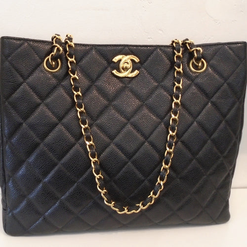 This Chanel Vintage Caviar Leather Tote Handbag has 24 karat gold hardware which includes the carrying/shoulder chain and the Chanel logo on the top front of the bag. This bag, along with its interior is black and has a zippered pocket inside also.