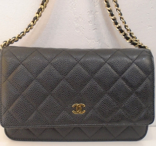 This Chanel Vintage Caviar Leather WOC is black with a diamond stitched pattern. It has gold tone hardware which includes the small chanel logo on the front center of the bag and the shoulder chain. The shoulder chain has a thin piece of leather woven between the chain links. This bag has an outside back pocket and black interior.