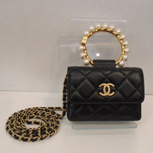 Load image into Gallery viewer, This Chanel Vintage Faux Pearl Clutch With Chain has the stitched diamond pattern and gold toned hardware which includes the Chanel Logo on the front center of the bag, the shoulder chain and the carrying handle. The shoulder chain also has a thin strip of leather woven between the chain links. The carrying handle has faux pearls sitting on the carrying handle.

