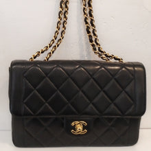 Load image into Gallery viewer, This Chanel Vintage Border Single Flap has the diamond stitch pattern except for an outside border. The front flap has a lip containing the gold Chanel logo clasp. It has a double gold chain shoulder strap with a strip of black leather woven between the chain links. The interior of this bag is burgundy and has a zippered pocket.
