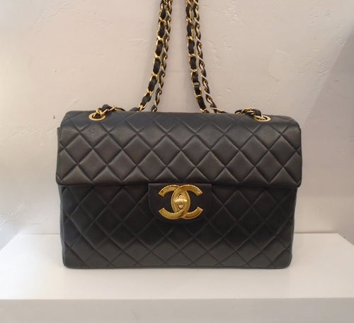 This Chanel Vintage Collectable has 24 Karat Gold Plated hardware. The CC logo clasp has an indented square on one of the Cs. The body of the bag is diamond stitched lambskin and it has a pocket on the back. It has a double shoulder chain with a thin black leather strip woven between the links. The interior of this bag is burgandy.