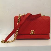 Load image into Gallery viewer, This Chanel Vintage Tomato Caviar Leather Top Handle bag has matte gold toned hardware which includes the logo and chain/leather shoulder strap. The interior of this bag is also tomato red and has a zippered pouch.
