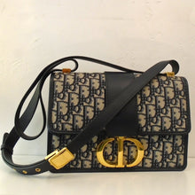 Load image into Gallery viewer, This Dior Navy Oblique 30 Montaigne  has gold hardware which includes the Dior Logo Clasp and Dior signature buckle on the shoulder strap. The interior of this bag is also navy.
