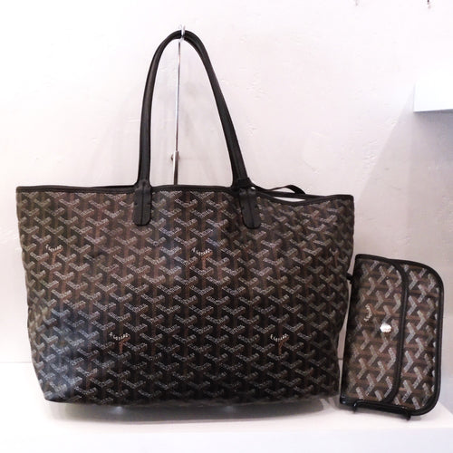 This Goyard Black/Brown Saint Louis PM is in the original Goyard pattern and includes a snap wallet which is attached to the bag. The interior of the bag is a soft cream color.