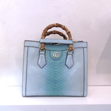 Load image into Gallery viewer, This Gucci Vintage Blue Python Diana Bag is a sky blue with a greenish blue down the center of the bag.  It has the Gucci logo in gold on a top center lip of the bag and double bamboo carrying handles. The interior of this bag is also sky blue. This bag comes with a guitar strap and a sky blue shoulder strap.
