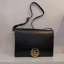 Load image into Gallery viewer, This Gucci Vintage Double Logo Shoulder Bag is black with gold hardware which includes the front clasp which is the Gucci Logo with a ring around it. The interior of this bag is green
