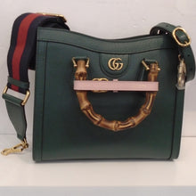 Load image into Gallery viewer, This Gucci Diana Medium Satchel is forest green, has bamboo carrying handles, an adjustable strap and a guitar strap. The interior of this bag is a soft cream.
