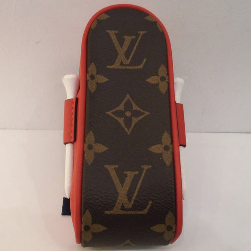 This Louis Vuitton Vintage Andrews Red Golf Ball Case has four gold tees and three golf balls included with the case. The golf balls have the Louis Vuitton Logo on them and the golf tees are white. The case is in the original Louis Vuitton Monogram pattern with red trim.