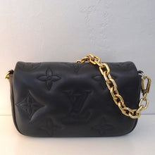 Load image into Gallery viewer, This Louis Vuitton Vintage Black Bubblegram Wallet has large embossed monogram. It has gold hardware which includes a heavy chain which is detachable. It also includes a guitar strap which is also detachable. The interior of this bag is black.
