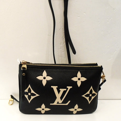 This Louis Vuitton Vintage Bicolor Empreinte Leather Double Zip Pochette is a unique design of three pochettes made into one bag. It is a lovely black bag with cream colored monogram. The shoulder strap is adjustable and detachable. The interior of this bag is a soft black.