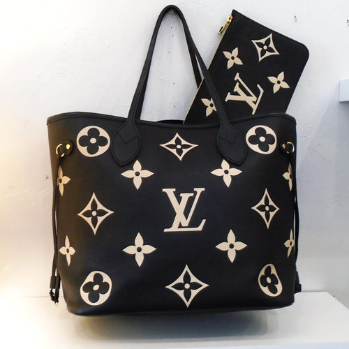 This Louis Vuitton Vintage Bicolor Empreinte Leather Neverfull MM is black with cream colored large monogram. It comes with a pouch of the same color and design. The interior of this bag is black.