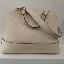 Load image into Gallery viewer, This Louis Vuitton Vintage  Beige Empreinte Leather Alma Neo BB has the original Louis Vuitton Monogram embossed into the leather. This bag has gold hardware, a carrying handle and a shoulder strap. The interior color of this bag is a suede brown. 

