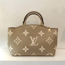 Load image into Gallery viewer, This Louis Vuitton Vintage Beige Empreinte Leather Petit Palais bag has the large Louis Vuitton monogram in cream on a beige color background. It has double carrying handles and gold hardware which includes the zippered top opening. The interior of this bag is a soft beige.
