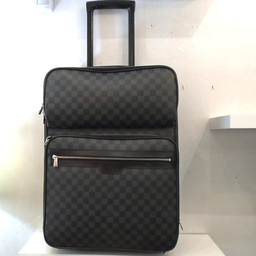 This Louis Vuitton Vintage Black Damier Graphite Pegase #55 has silver hardware, a pull out handle and wheels. It has two zippered sections on the front and a zippered section on the top of the case. It opens up and features multiple zippered sections inside the case.