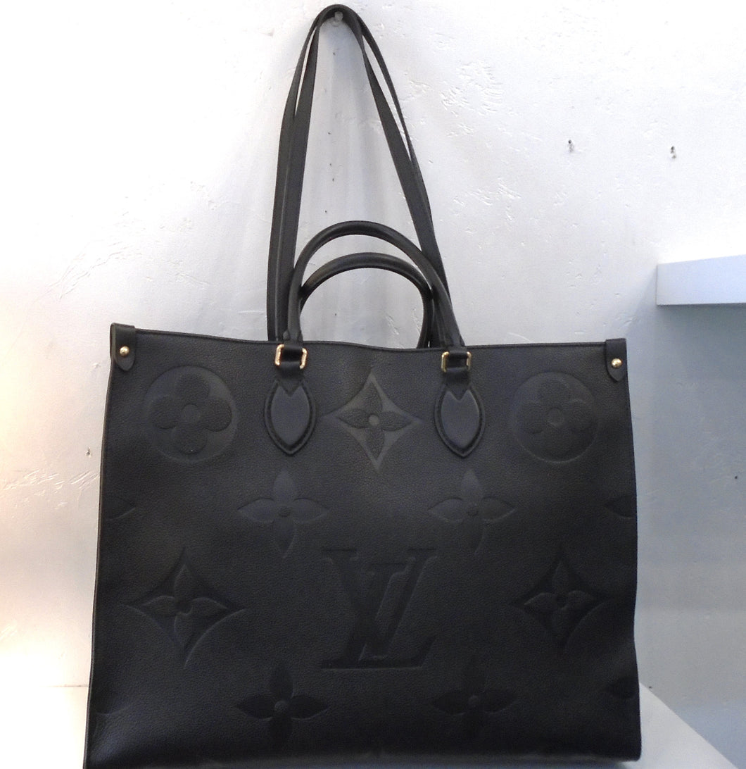 This Louis Vuitton Vintage Black Empreinte Leather On The Go GM has gold hardware, double carrying handles and double shoulder straps. The interior is a soft camel.