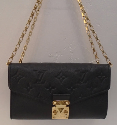 This Louis Vuitton Vintage Black Monogram Saint Germain Mini is embossed on empreinte leather. This bag has gold hardware, and a double shoulder chain. The interior is black, has a zippered pocket and holder for cards.