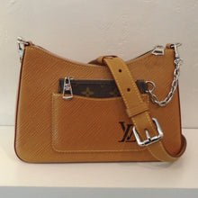 Load image into Gallery viewer, This Louis Vuitton Vintage Caramel Epi Leather Marelle has silver hardware and a front pocket with the Louis Vuitton logo in dark brown on the bottom corner. This bag has a change purse in original Louis Vuitton Monogram that is attached to the bag by a silver chain and the change purse fits into the front pocket of the bag. The bag has a shoulder strap and top zipper. The interior of this bag is dark brown.

